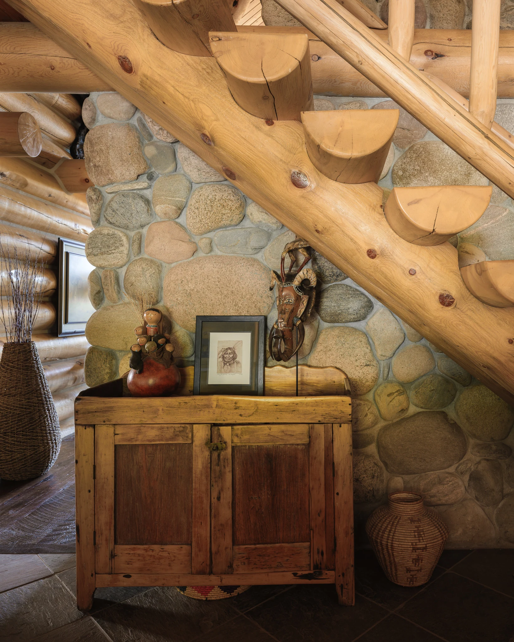 Styled console beneath a log stairway with Western decor — interior design photography Livingston Montana, Bear Canyon Ranch